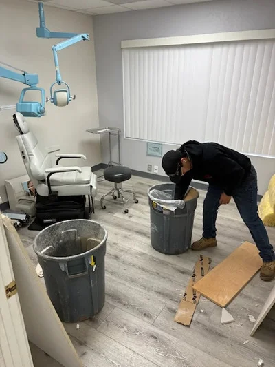 Dental office cleanout with removal of chairs, overhead lights, and waste containers