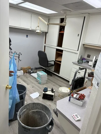 Empty commercial room with cleared junk, buckets, and hauling equipment removed