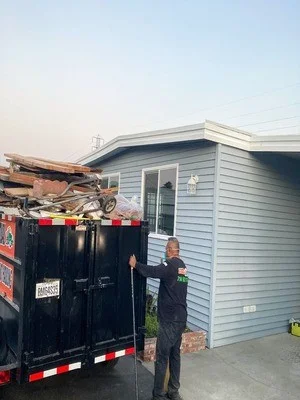 Commercial hauling truck loaded with residential junk and debris removal materials